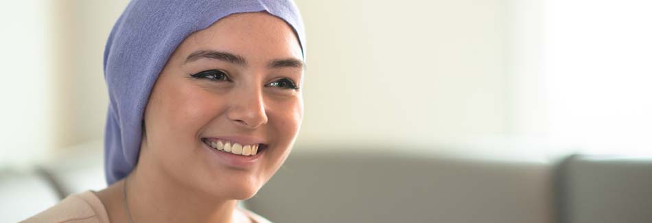 A young woman smiles at Baptist’s cancer treatment center in North Mississippi